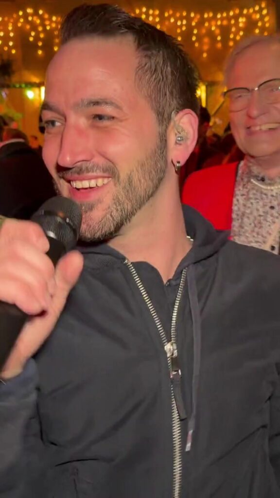 Yves Flade, Frontman von Music2Dance, lacht beim Singen